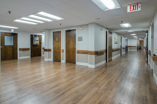 A well-lit corridor featuring several doors, showcasing a clean and spacious interior.