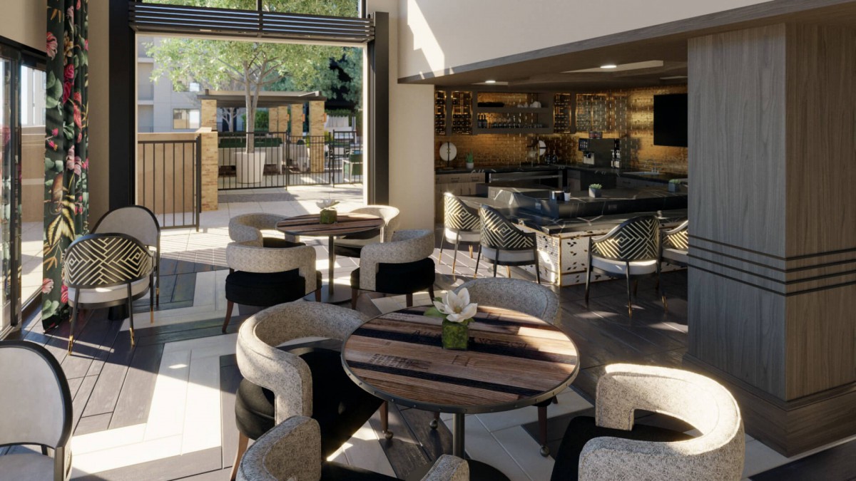 A modern restaurant interior featuring stylish seating and a well-lit bar area.