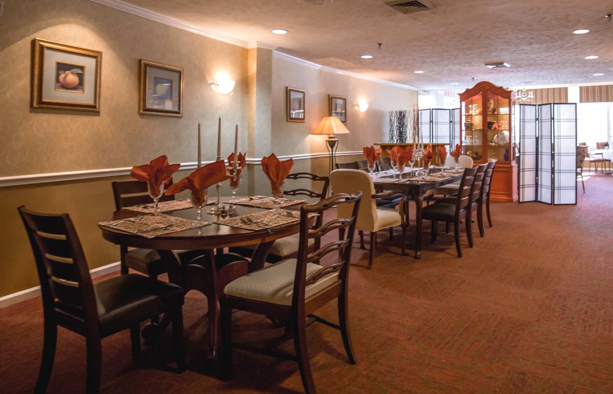 A cozy and elegant dining area in a restaurant with neatly arranged tables and chairs.