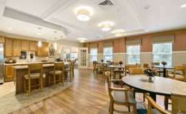 A spacious dining and kitchen area with comfortable seating and modern lighting.