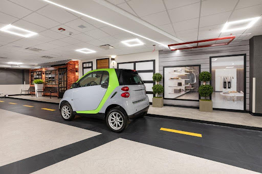 A compact electric car showcased in a modern indoor environment.