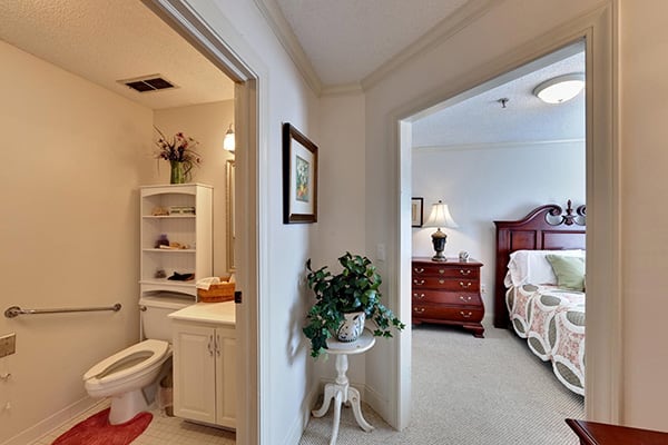 View of a bedroom and bathroom in a cozy home setting.