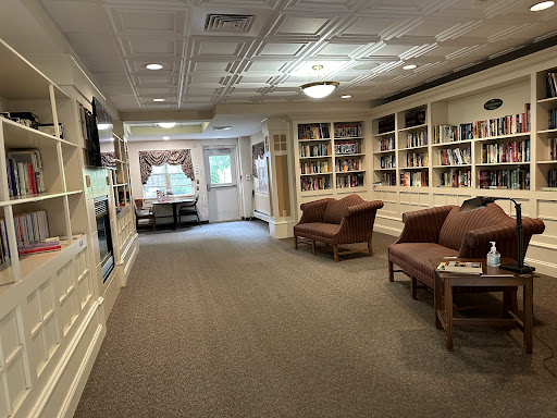 A cozy reading area featuring bookshelves and comfortable seating.
