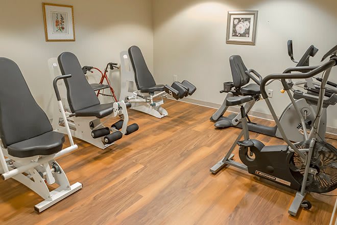 A small gym room equipped with various exercise machines.