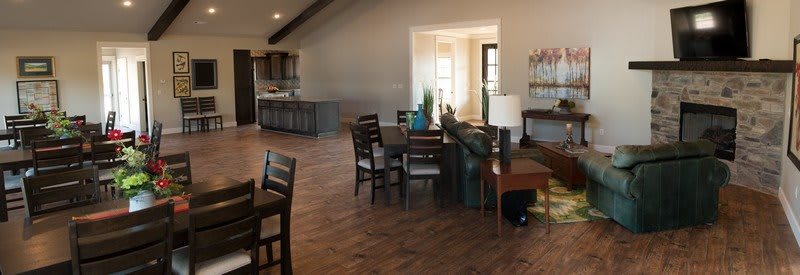 A spacious open floor plan featuring a modern living and dining area with wood flooring.