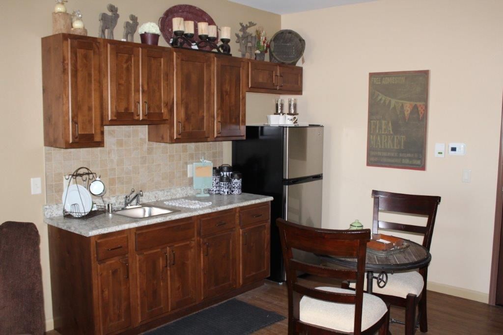 A cozy kitchen with wooden cabinets and a small dining area.