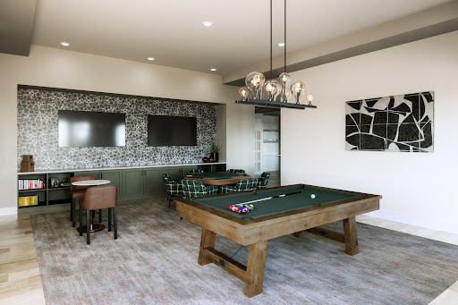 A stylish game room featuring a pool table, comfortable seating, and modern decor.