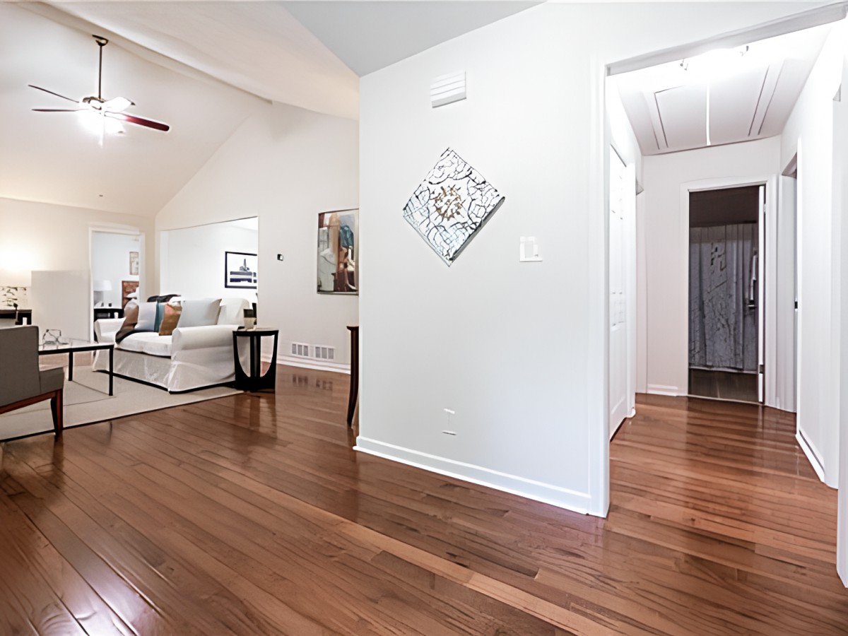 A modern living room with hardwood flooring and elegant decor.