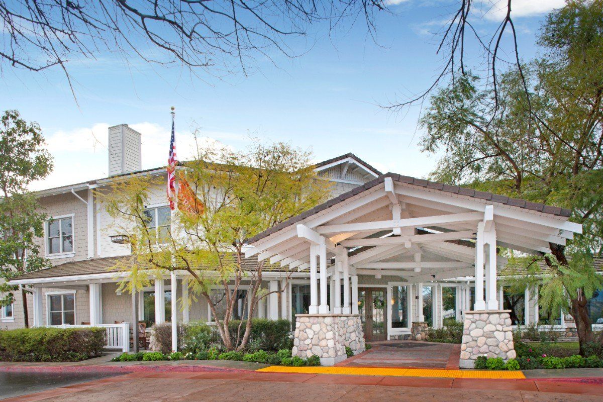 A welcoming entrance to a building surrounded by trees.