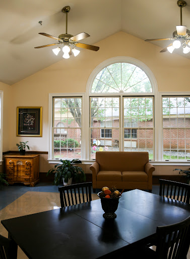 A cozy living room filled with natural light and comfortable furnishings.