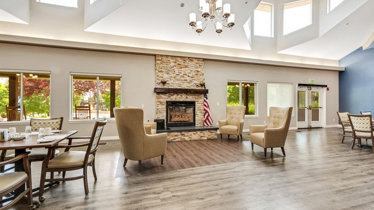A cozy living room with a stone fireplace and elegant seating.