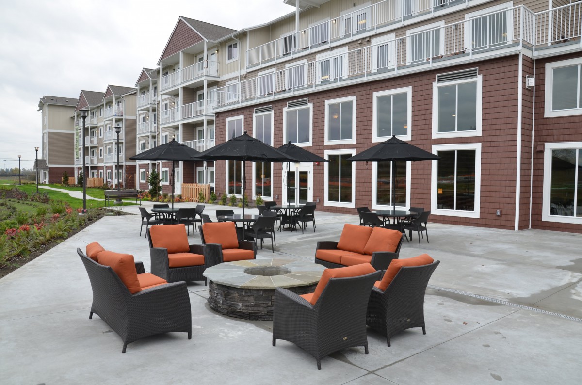 A beautifully designed hotel patio featuring comfortable outdoor seating and a fire pit.