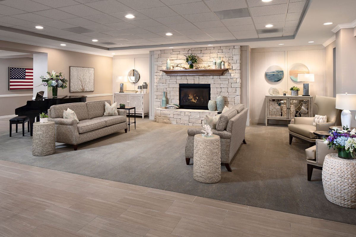 A modern and cozy living room with a stone fireplace, stylish furniture, and tasteful decor.