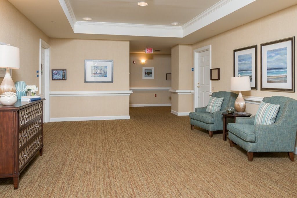 A cozy hallway with comfortable seating and wall decorations.