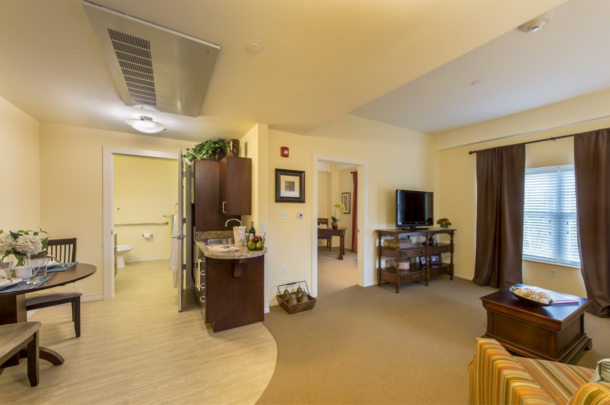 A cozy living room with comfortable furniture and a television.