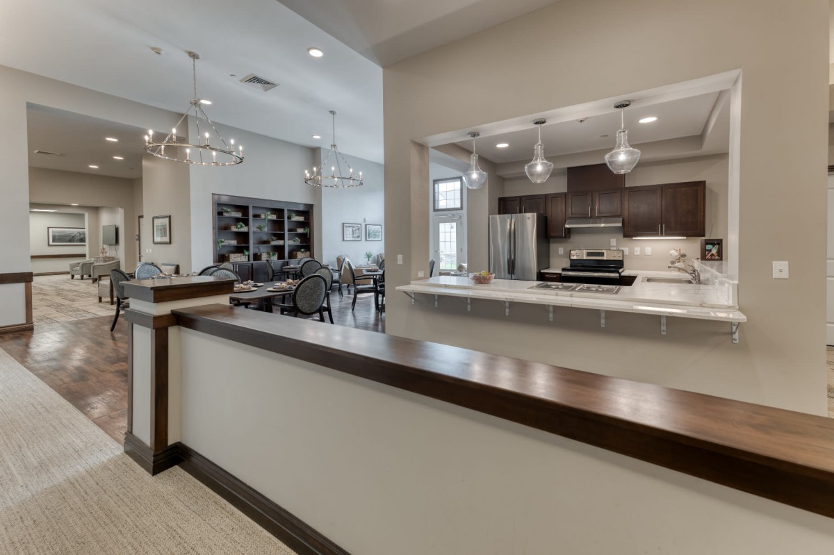A modern open-concept kitchen and dining area with stylish lighting.