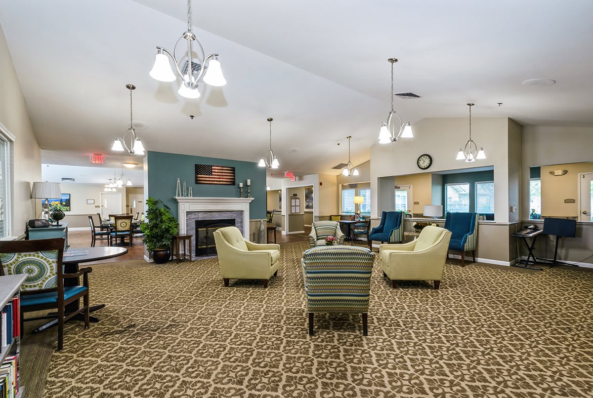 A spacious and well-lit lobby area with comfortable seating and a decorative fireplace.