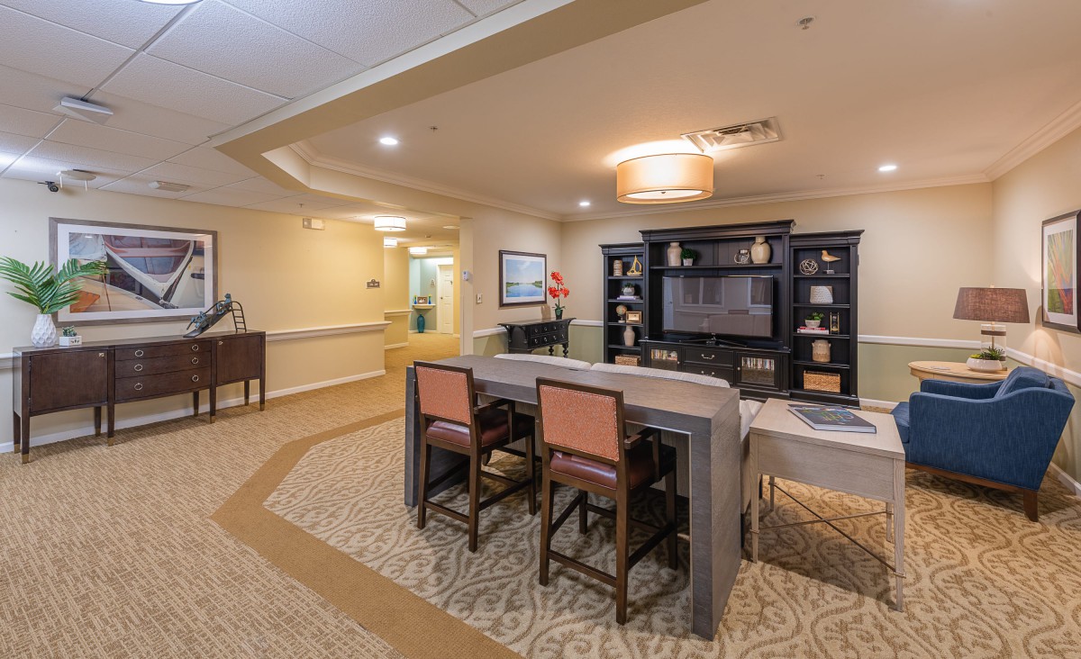 A cozy living space with a dining area and shelves for decor.