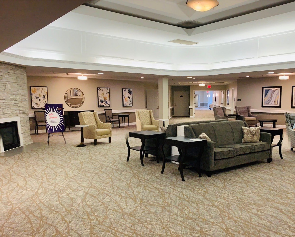 A spacious lobby area featuring sofas and chairs, with elegant decor and lighting.