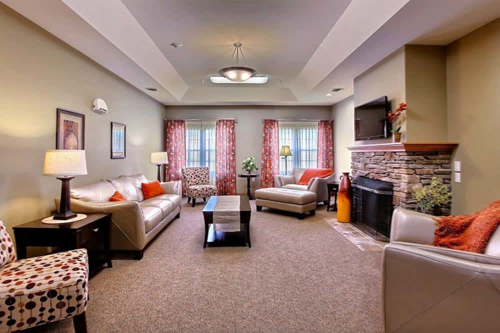 A cozy living room with modern furniture and a fireplace.