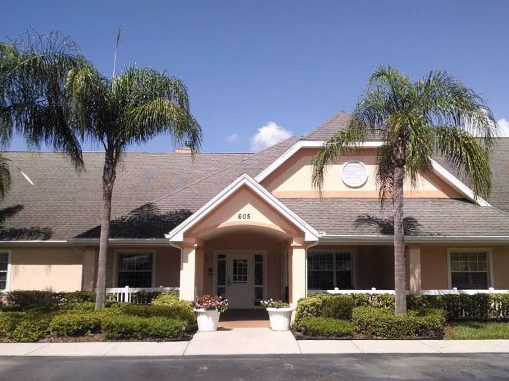 A picturesque building with palm trees on a sunny day.