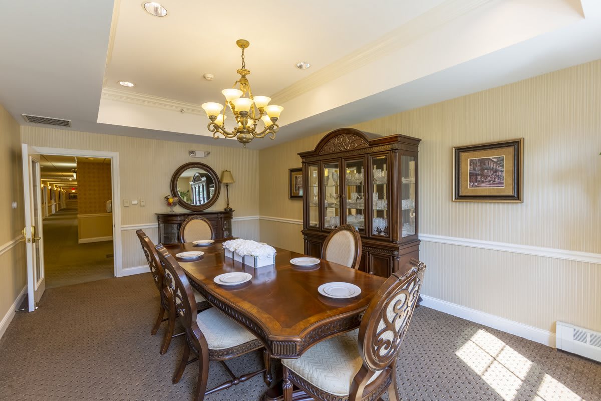 A well-decorated dining room with a wooden table, chairs, and a chandelier.