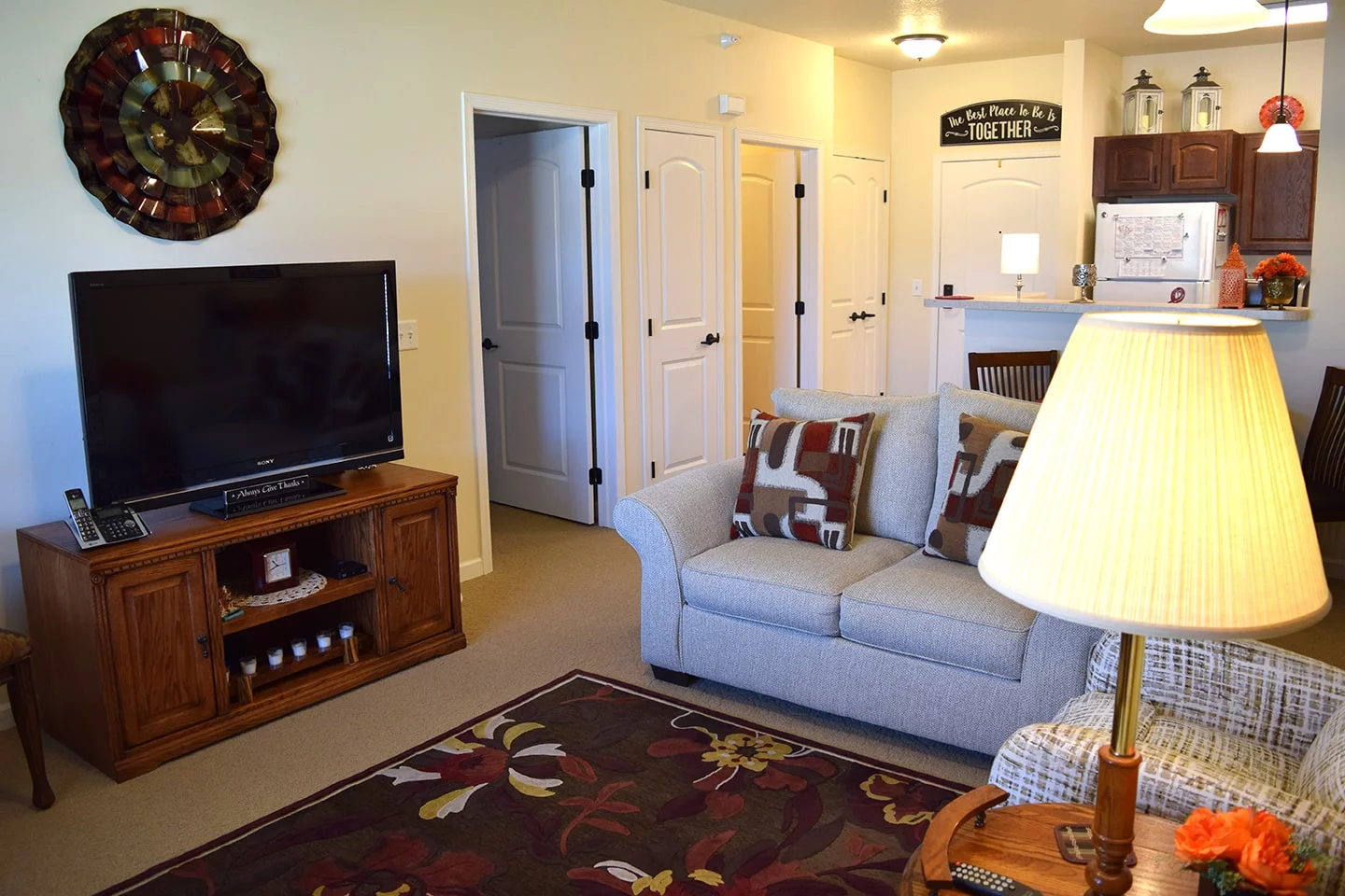 A cozy living room with a sofa, television, and home decor.