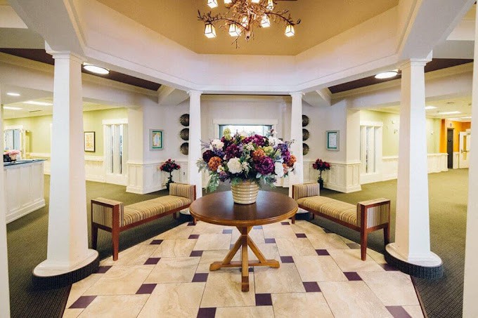 A well-decorated lobby with floral arrangements and comfortable seating.