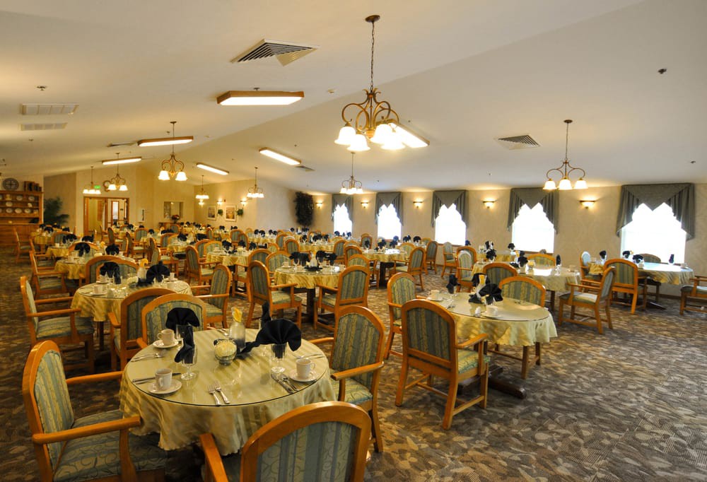 An elegantly decorated dining room with neatly arranged tables and chairs.
