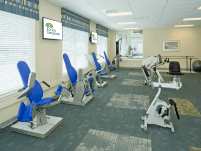 Interior view of a fitness center with exercise machines lined up.