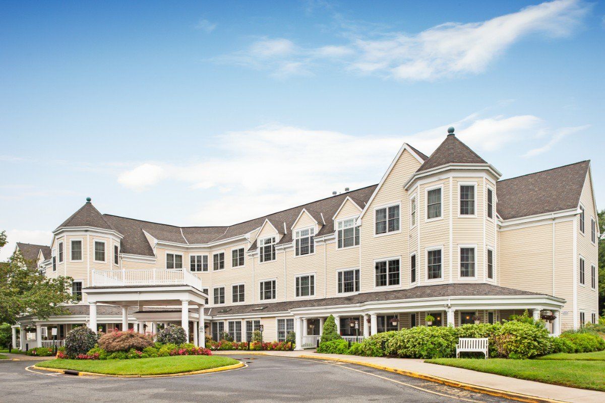 A residential building with landscaped surroundings under a clear blue sky.