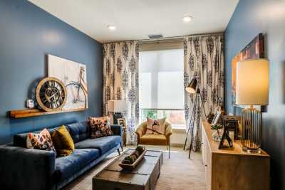 A stylish living room with blue walls, modern furniture, and decorative elements.