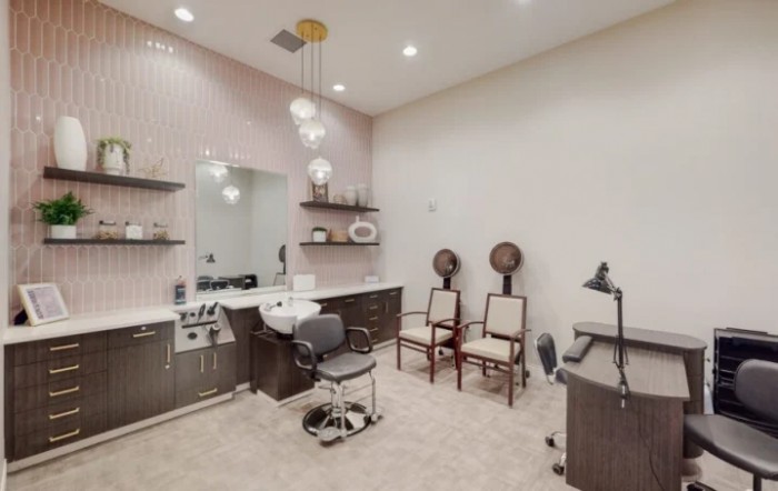 A well-equipped salon interior with styling station and seating.