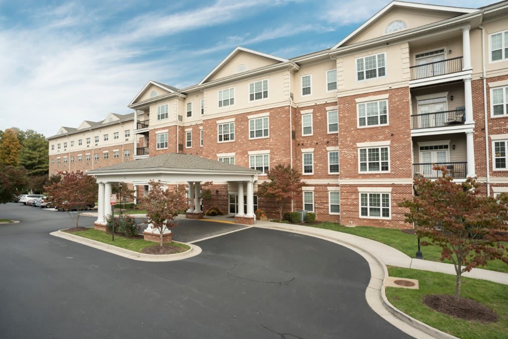 A multi-story residential apartment building with a covered entrance.
