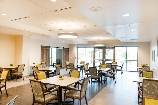 A well-lit modern dining area featuring stylish furniture and ample natural light.