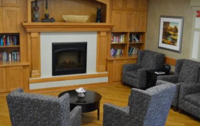 A cozy living room with a fireplace and comfortable seating.