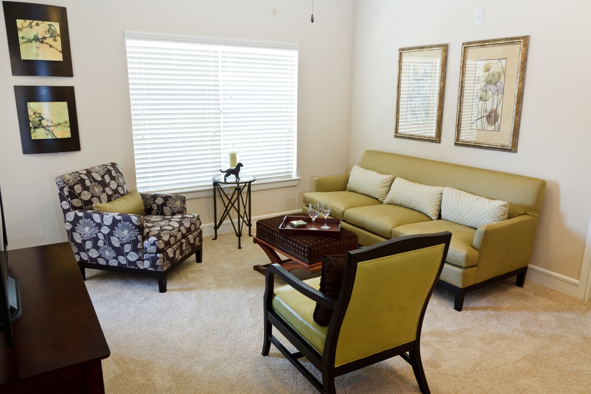 A cozy living room with a sofa, armchairs, and a coffee table.