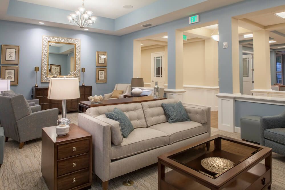 A modern living room with stylish furnishings and blue walls.