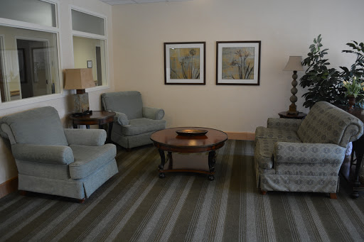 A cozy living room featuring comfortable seating and decorative wall art.