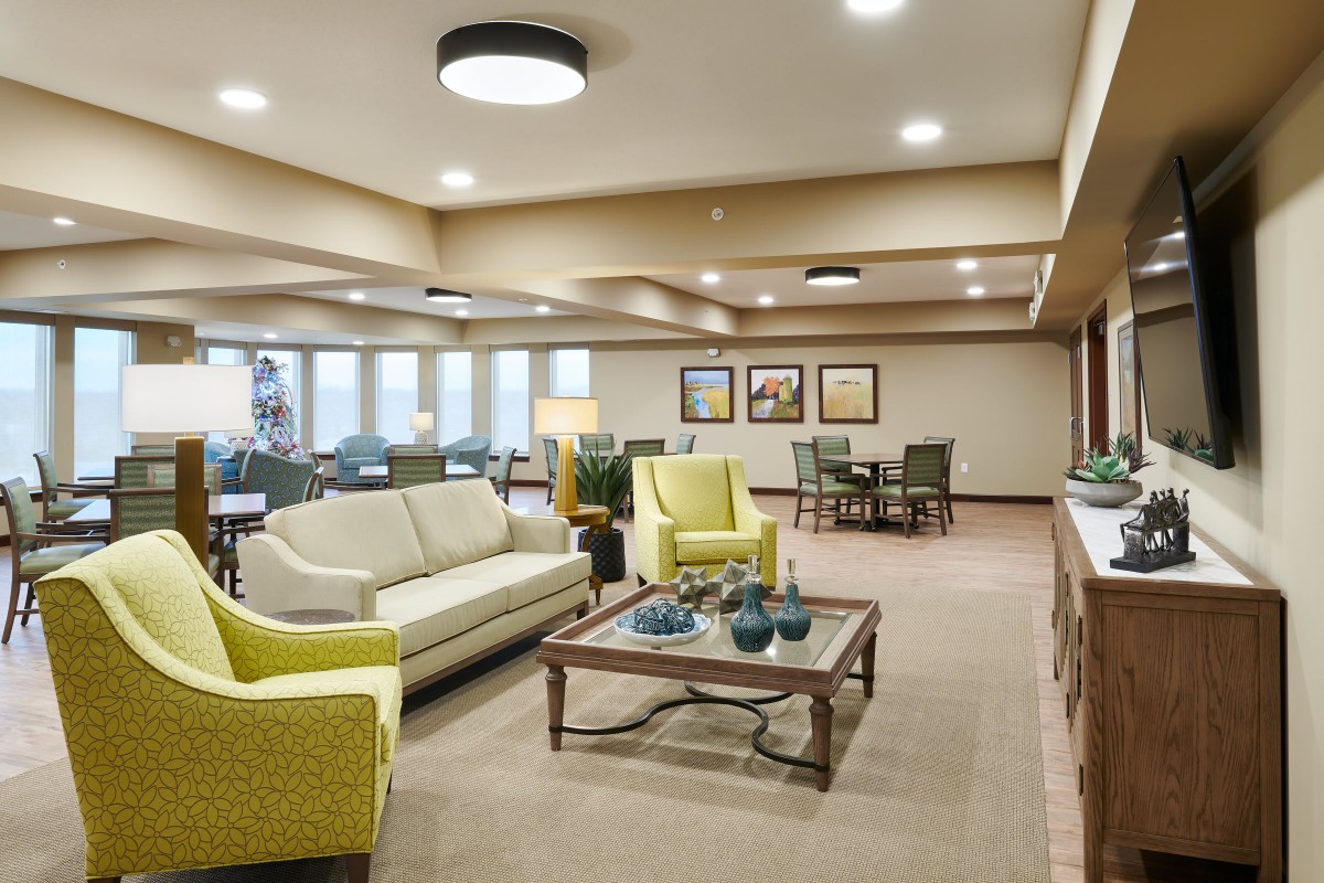 A spacious and well-lit living room with comfortable seating and elegant decor.