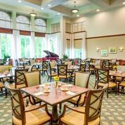 An elegant restaurant dining room with neatly arranged tables and chairs.
