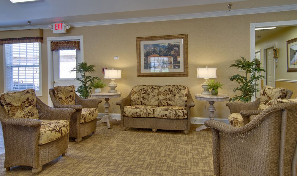A cozy living room with floral-patterned furniture and ambient lighting.