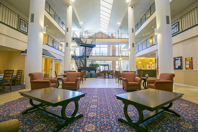 A spacious and modern lobby with comfortable seating, skylights, and a stylish design.