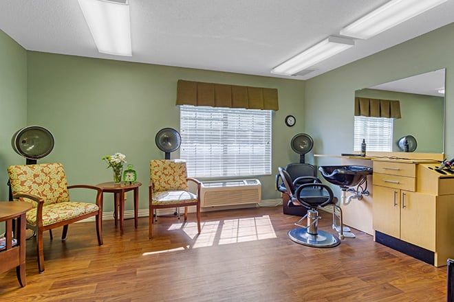A well-lit hair salon interior with styling chairs and a mirror.