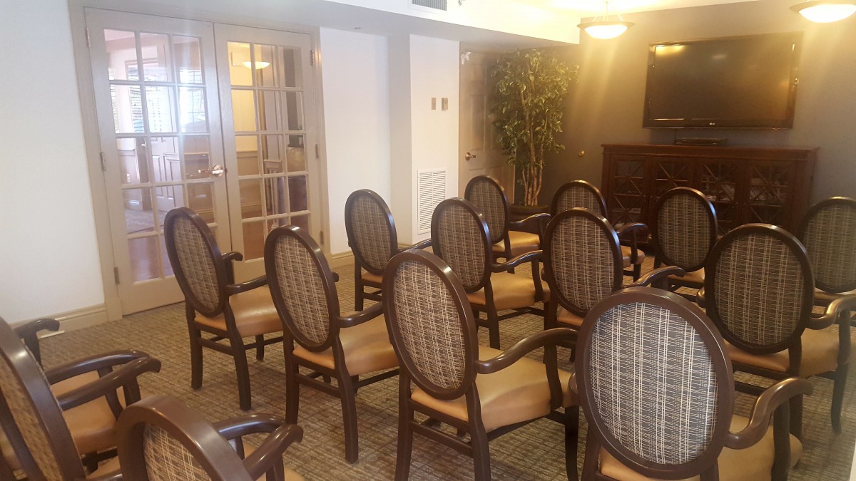 An empty conference room with neatly arranged chairs.