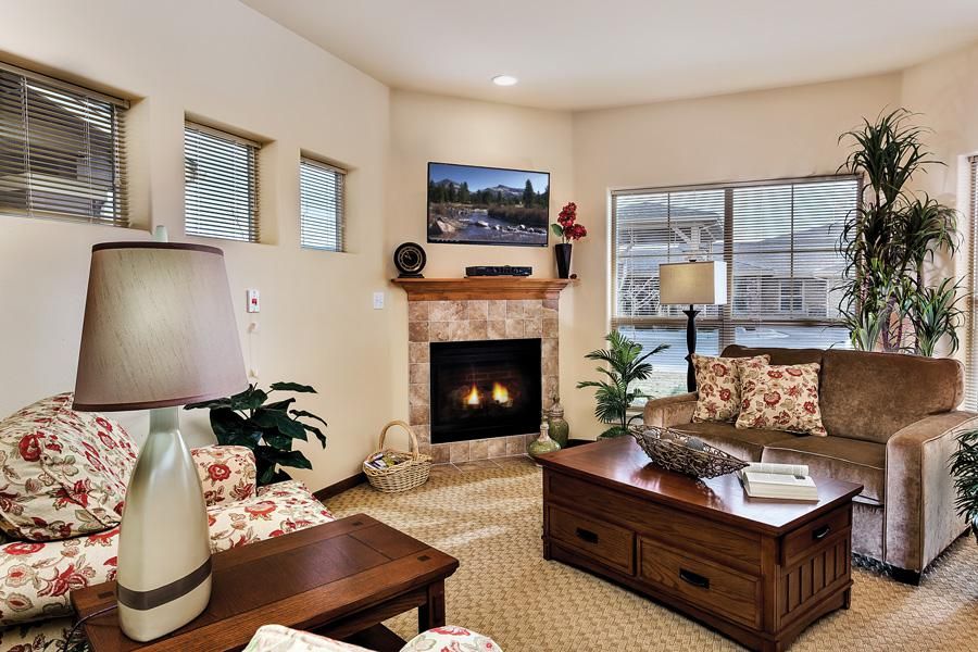 A cozy living room featuring a fireplace, comfortable seating, and tasteful decor.