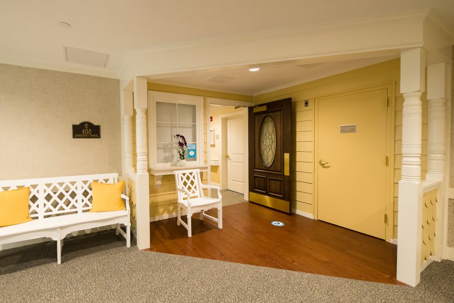 A cozy hotel lobby with seating and an entrance door.