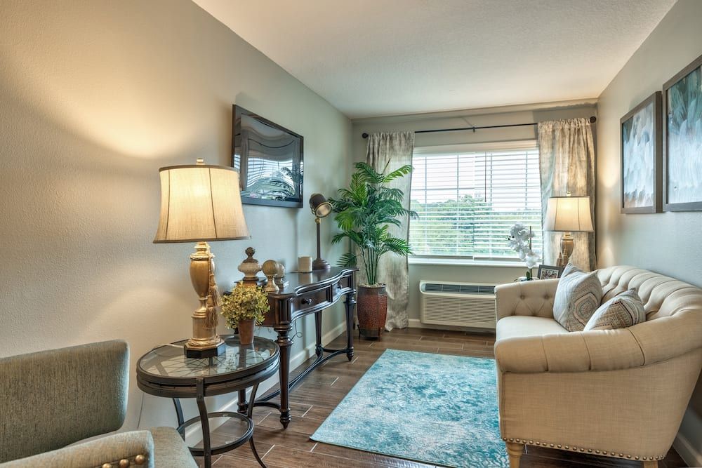 A cozy living room with elegant furniture, warm lighting, and tasteful decor.