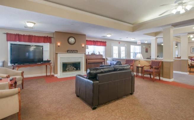 A spacious living room with a fireplace, TV, and comfortable seating.