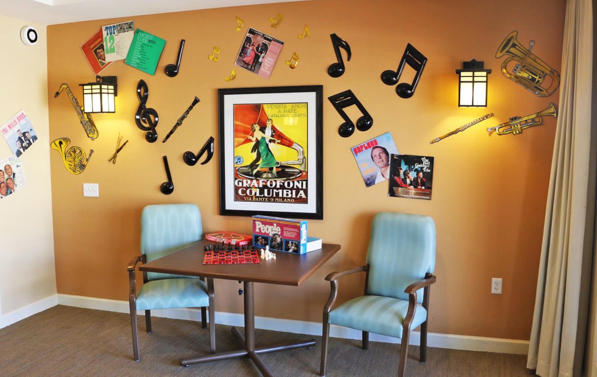 A cozy corner with a music-themed decor featuring vintage posters and musical notes on the wall.